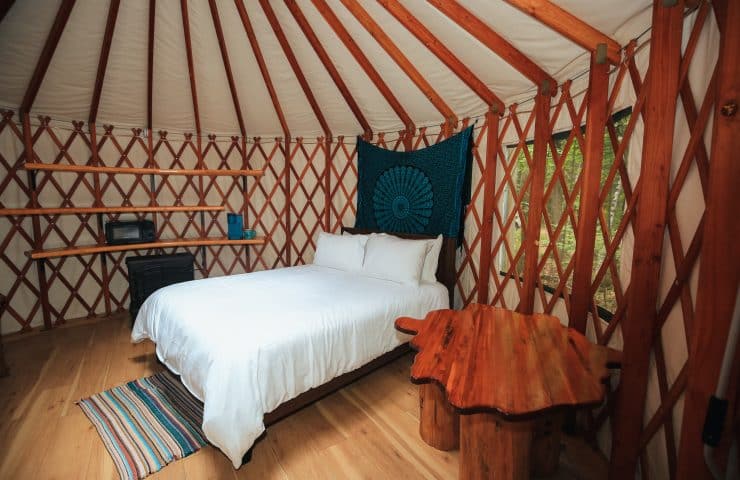 Stay cozy in a queen size bed in the Wildman Yurt