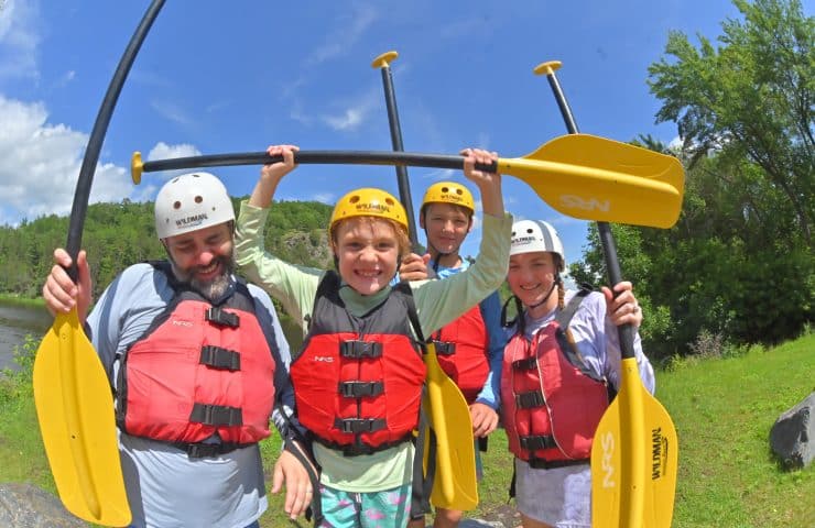 Family with kids geared up for a wisconsin whitewater rafting trip