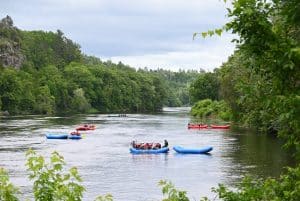 a fleet of Wildman Resort rafts on the Menominee River in Niagara Wisconsin