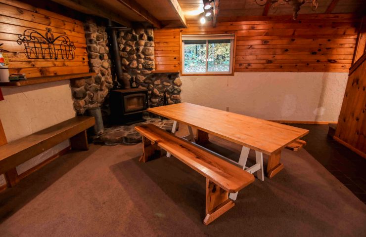 image of Peshtigo Lodge cabin kitchen dining table in front of fireplace