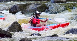 A rafter paddles through Horserace Rapids on the Peshtigo River with Wildman Adventure Resort in Wisconsin